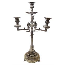 A large Victorian Thomas Bradbury & Sons silver plated candelabrum, the circular base with flower head border upon three domed feet, supporting a central knopped and fluted column flanked by three zoomorphic creatures, leading to a central socket with removable nozzle above a large palmette detailed drip pan, and three scrolling branches with conforming sockets and nozzles, with maker's silver plate mark and Victorian registration lozenge beneath, H62.5cm