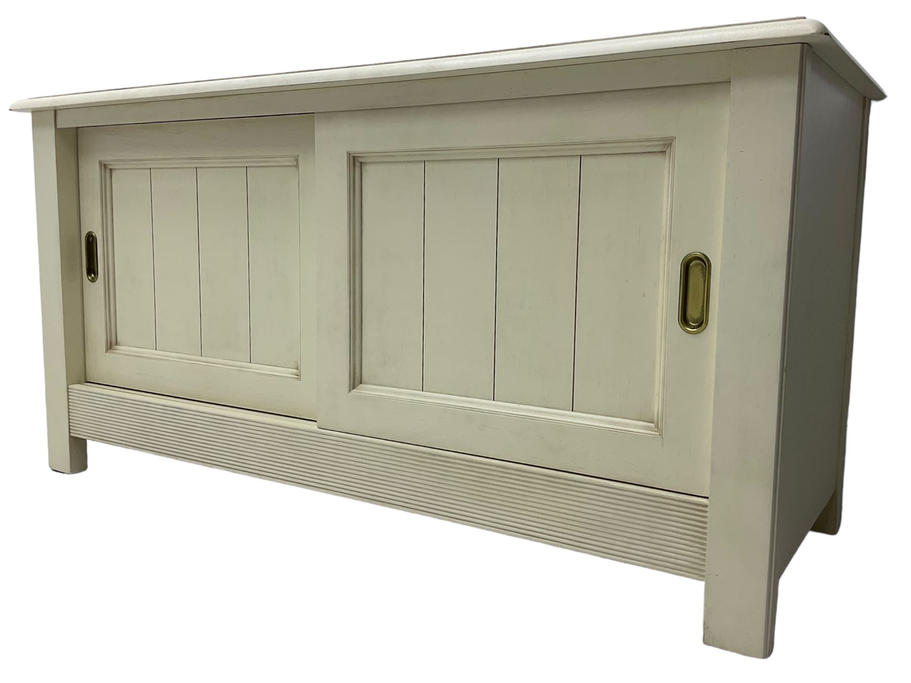 Cream finish low side cabinet, moulded rectangular top over two sliding panelled doors, on stile supports 