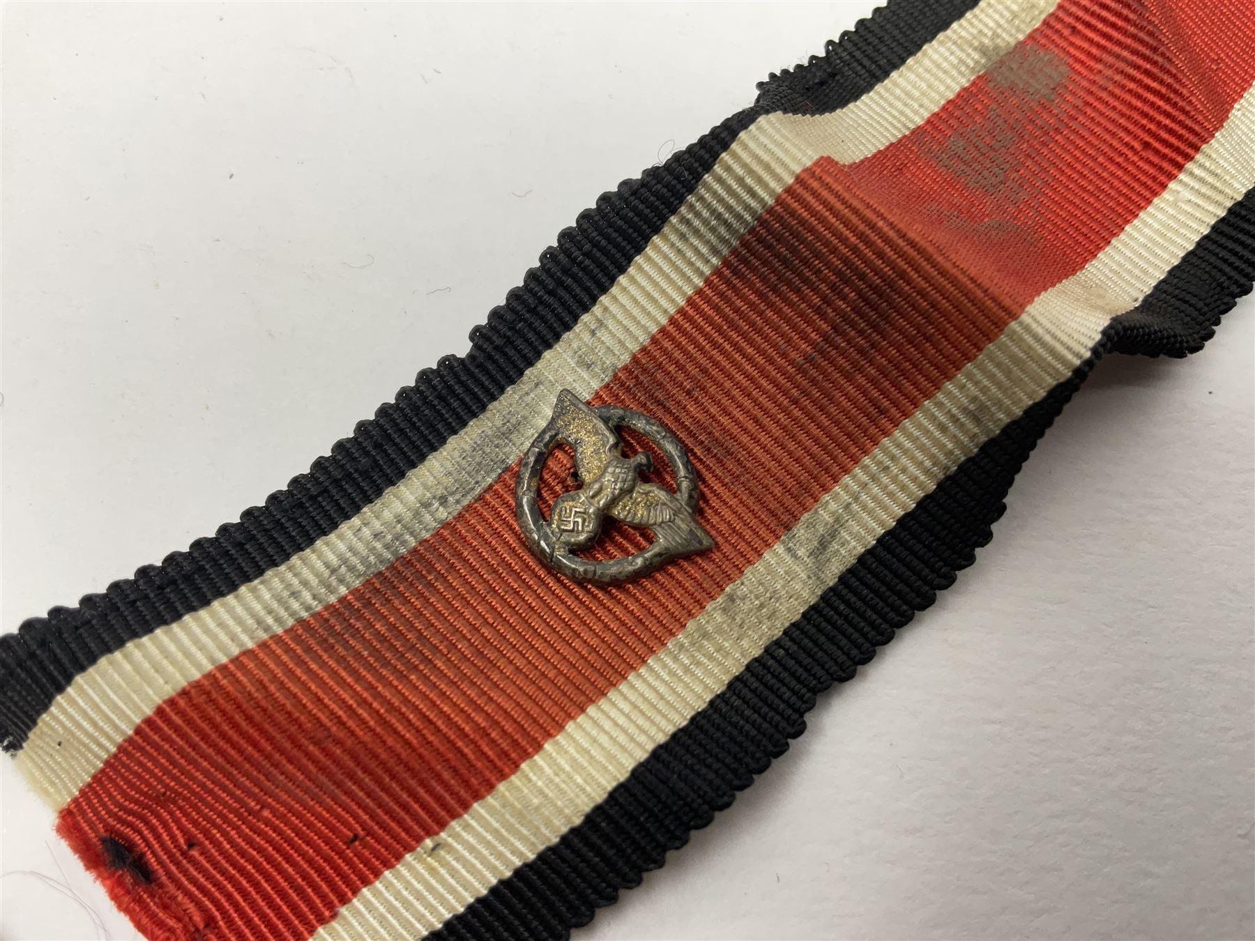 Collection of eleven German metal and cloth badges and uniform buttons including driver's badge, two 'SS' fabric skulls, private's shoulder tabs, Police cloth badge, tank destruction badge, medal bars and ribbon etc; most WW2 period