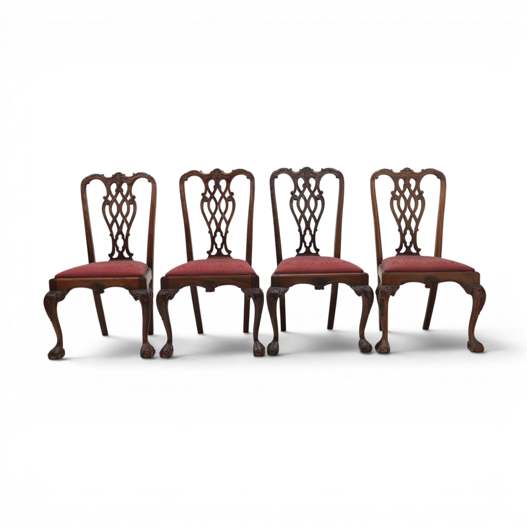 Chippendale design set of ten (8+2) mahogany dining chairs, serpentine cresting rails with carved detail over pierced ribbon-tied splats, red damask upholstered drop-in seats, on cabriole supports with acanthus carved knees and claw and ball feet
