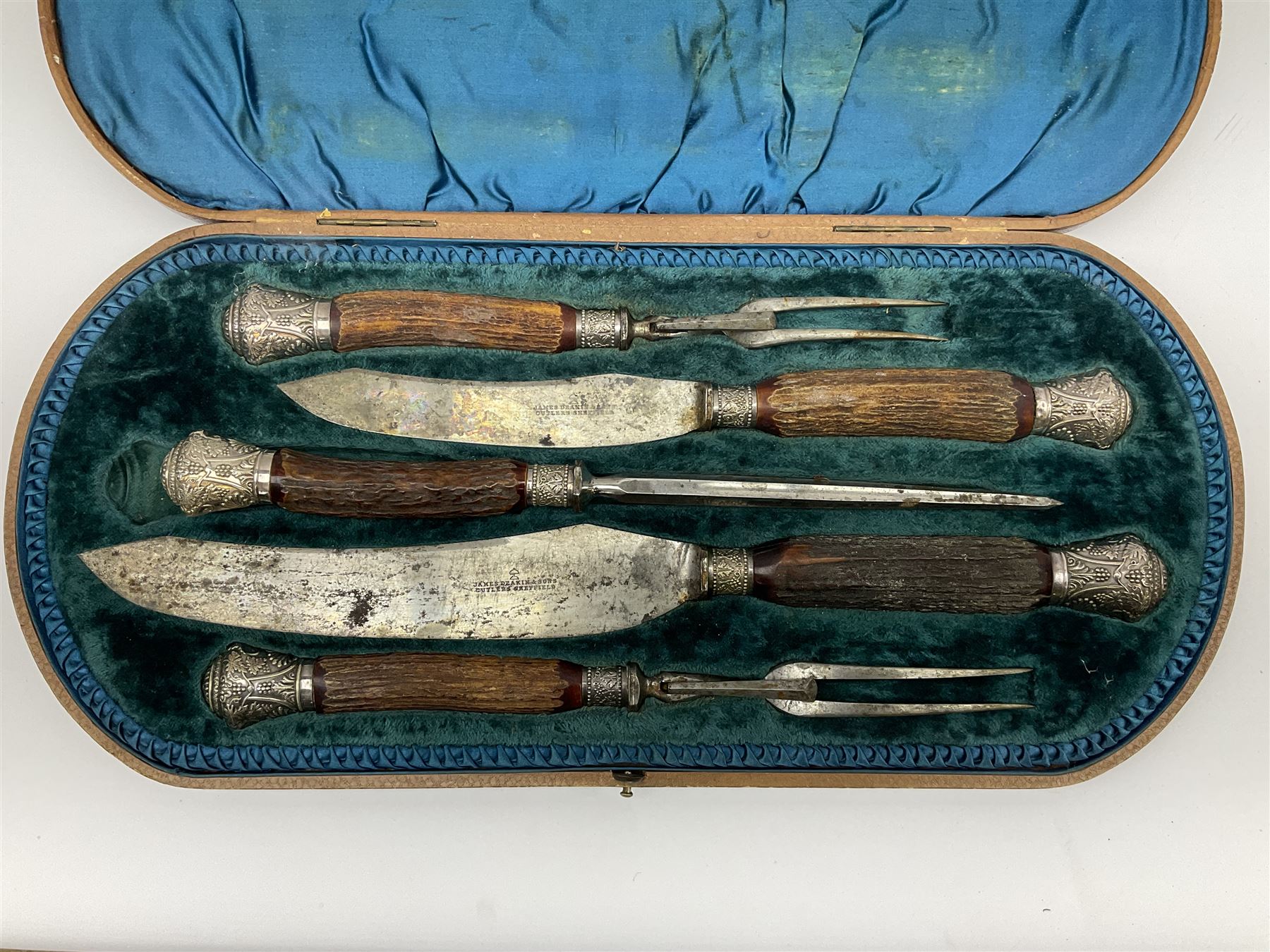 Victorian carving set, the blades stamped James Deakin and Son, Cutlers Sheffield, with part antler handles and silver plated foliate mounts, in B. Barnett of Hull lined fitted case, L47cm