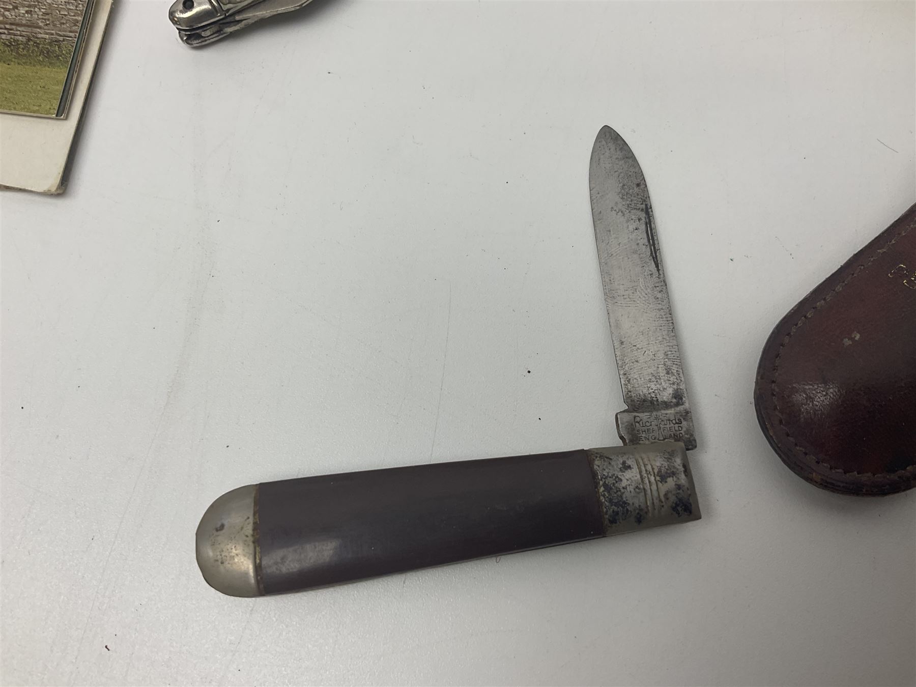 Seven pen knives, two lighters, including one Ronson example and a collection of postcards