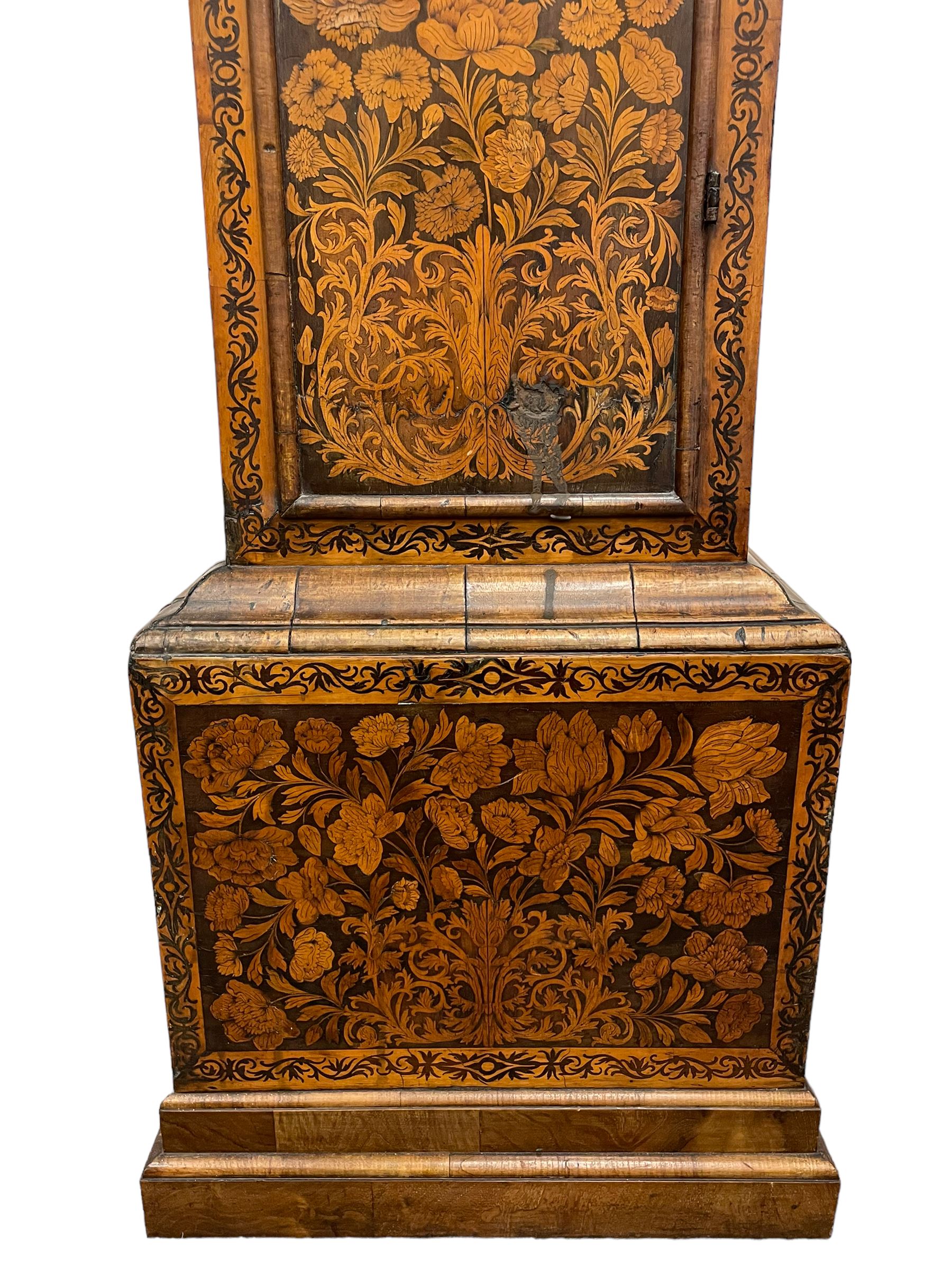William & Mary floral marquetry 8-day longcase clock c 1700, later mid-18th century four pillar rack striking movement with a square brass dial and subsidiary seconds dial, ringed winding holes and calendar aperture to the matted dial centre, with London cherub head cast spandrels and (later) fretted steel hands, silvered Roman numeral chapter ring with stylised fleur di Lis half hour makers, narrow Arabic five-minutes, minute track and inner quarter hour track, signed Thomas Horlock, Hammersmith, 
case with box upstand to the domed floral marquetry decorated caddy with three brass flame finials, above a moulded cornice and fretwork frieze,  inlaid hood door with attached barley twist pillars to the front above an inlaid convex moulding, full length D moulded trunk door with a circular lenticle inlaid with floral and foliage panels inhabited with birds, on a conforming marquetry plinth with applied double skirting. Thomas Horlock is recorded as a Whitesmith & Clockmaker of Hammersmith, Middlesex.
A copy of Thomas Horlock's will dated the 15th June 1757 is held at The National  Archives Kew.