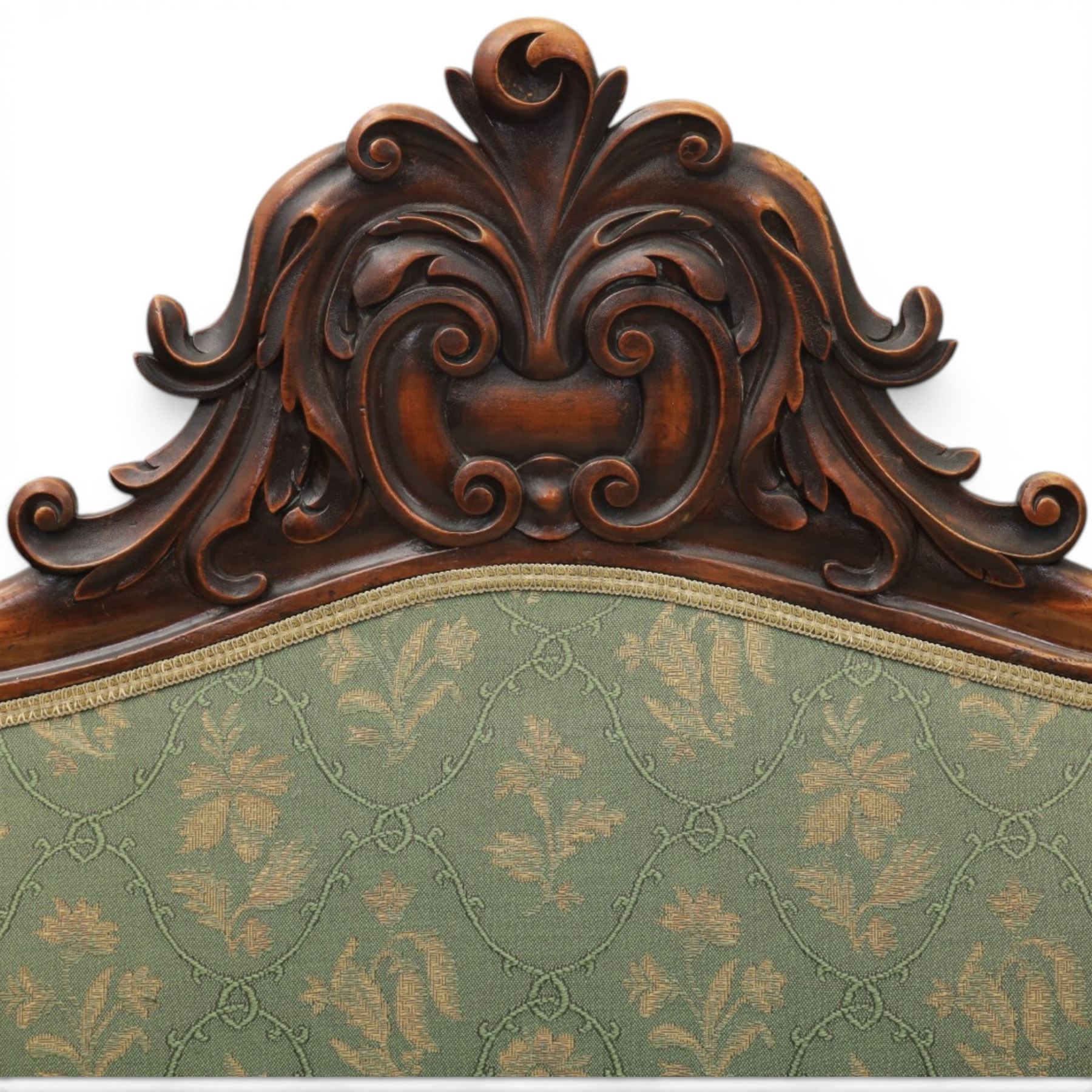 Victorian mahogany framed sofa, scroll arms with double camel back, green geometric upholstery, raised on turned supports