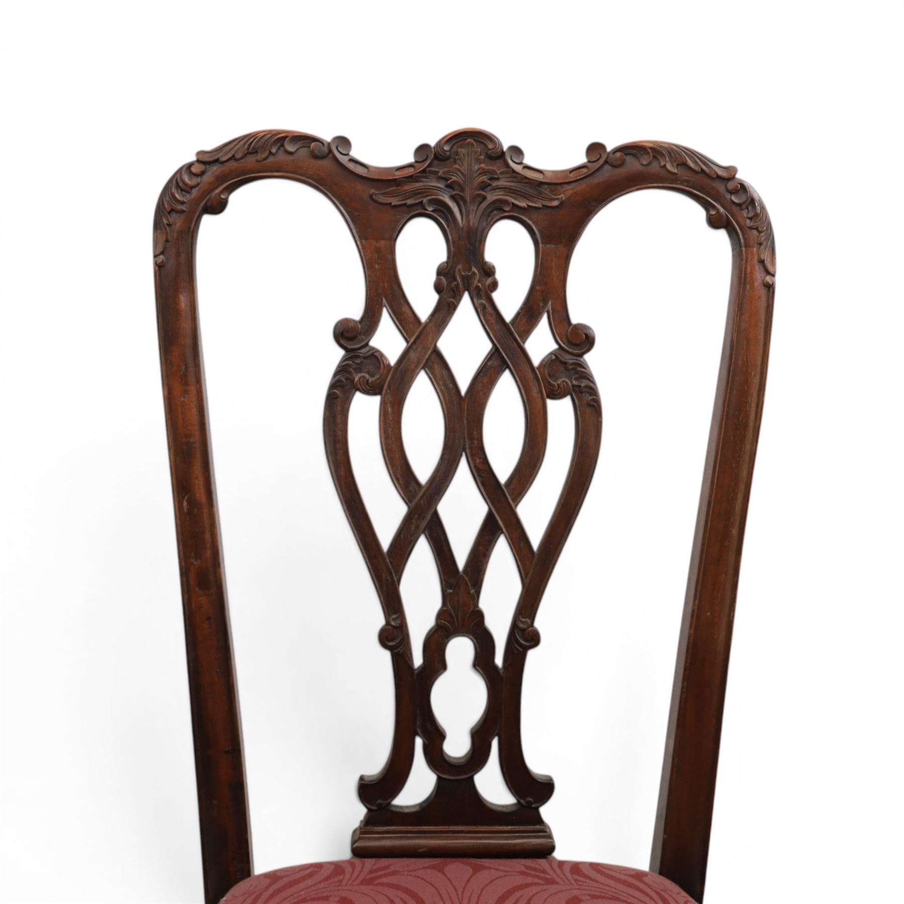 Chippendale design set of ten (8+2) mahogany dining chairs, serpentine cresting rails with carved detail over pierced ribbon-tied splats, red damask upholstered drop-in seats, on cabriole supports with acanthus carved knees and claw and ball feet