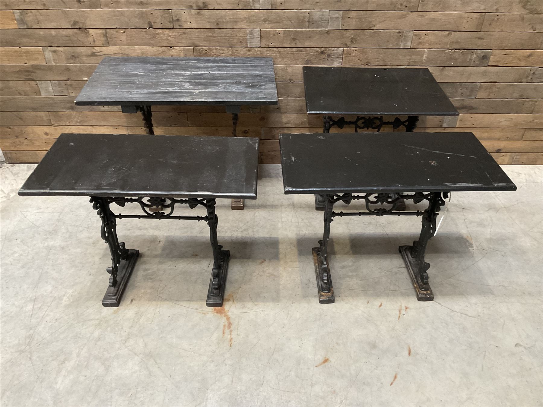 Four cast iron pub or bar tables with rectangular tops