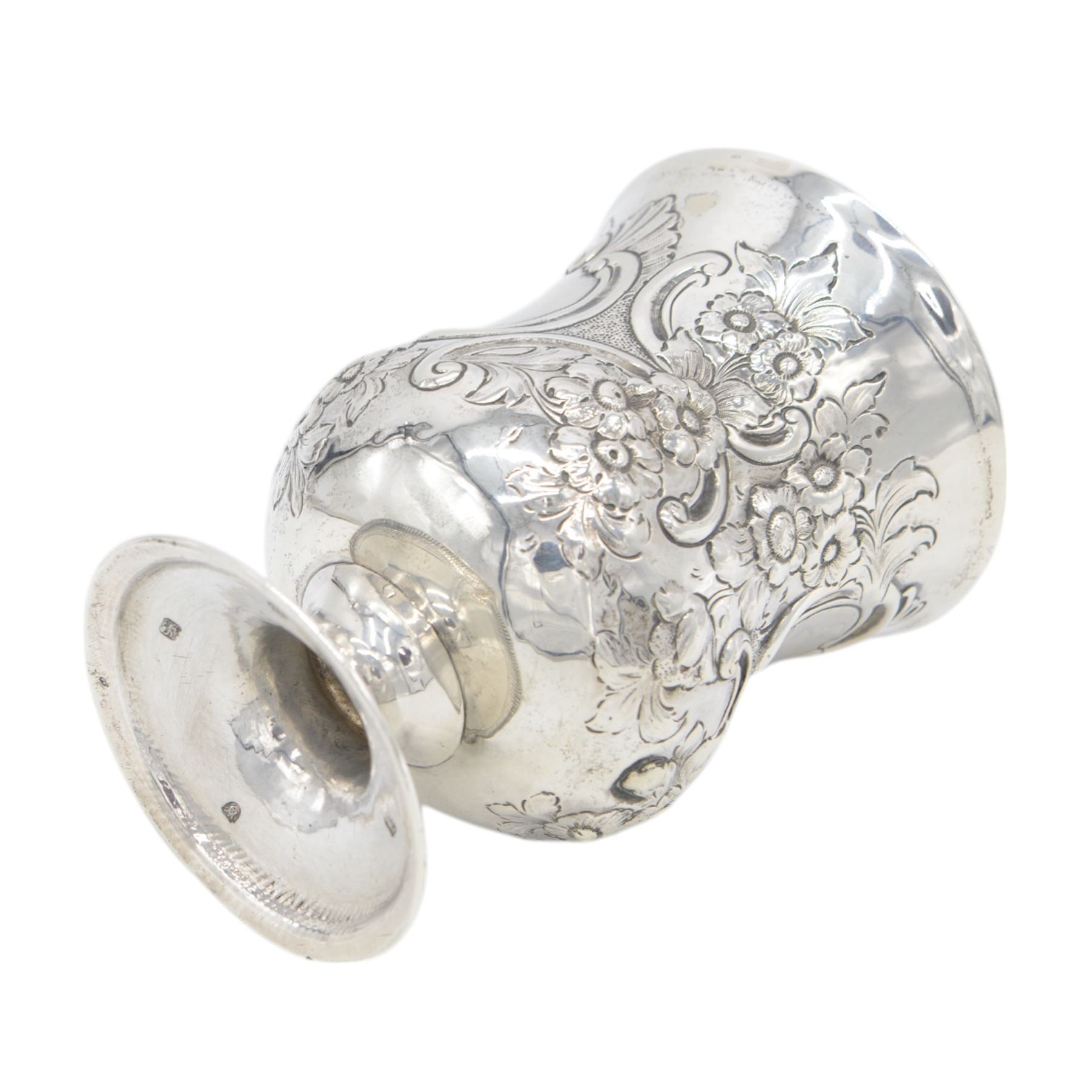 George III silver cup of circular form, embossed with scrolling and floral decoration, upon circular foot, hallmarked John Denzilow, London 1784, H13cm