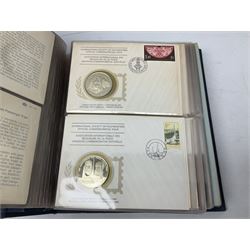Thirty-six 'International Society of Postmasters Official Commemorative Issues' sterling silver proof medallic covers dating from 1975 to1977, housed in the official folder