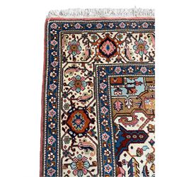 Large Persian carpet, the geometric and stylised floral medallion on rust ground field decorated with stylised plant motifs, guarded ivory border with repeating pattern