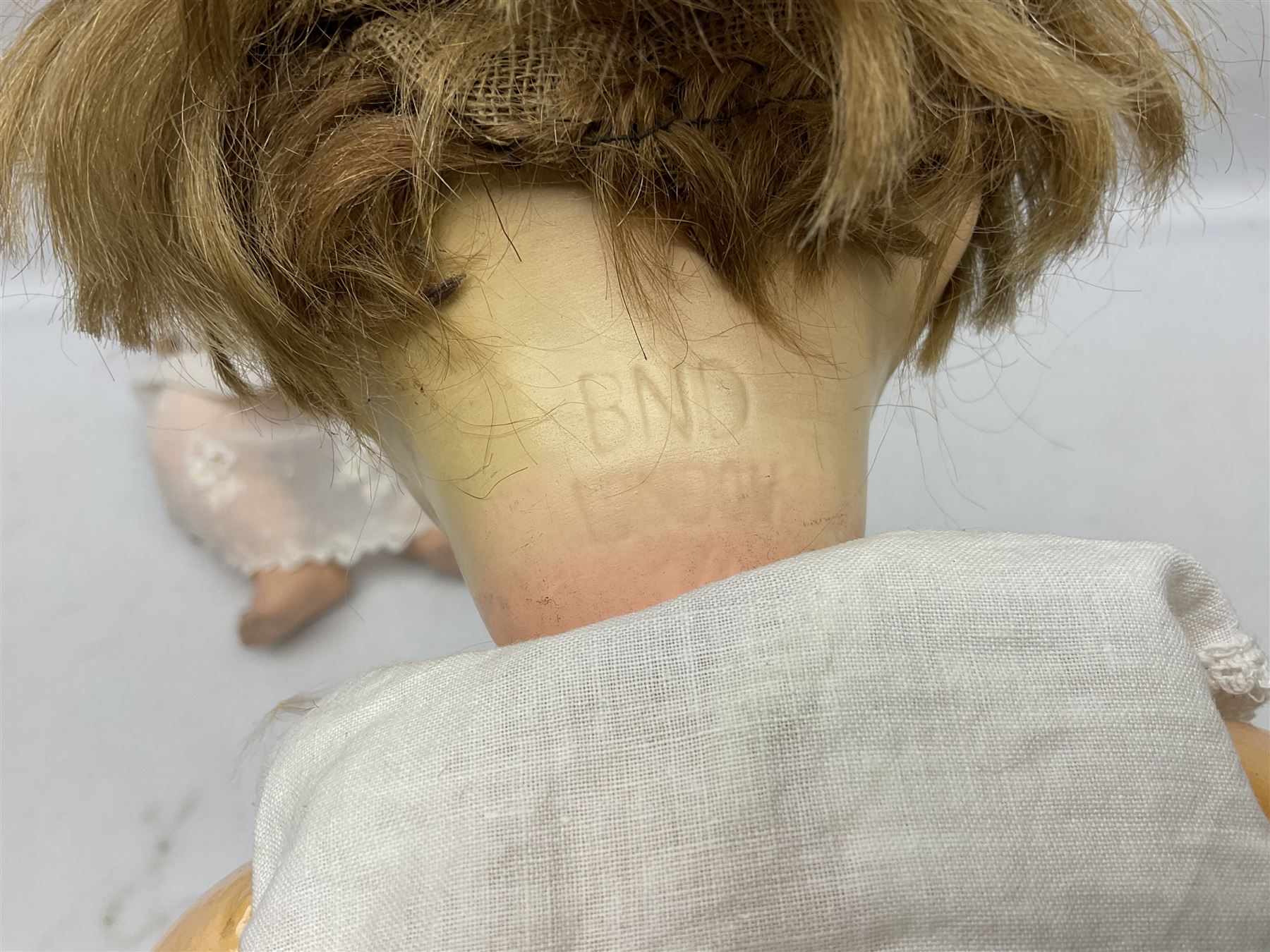 Heubach Koppelsdorf Germany bisque head doll with applied hair, sleeping eyes, open mouth with teeth and composition body with jointed limbs; marked 'Heubach Koppelsdorf 342.6/0 Germany' H34cm; Armand Marseille bisque head baby doll with moulded hair, sleeping eyes, open mouth and composition body with jointed limbs; marked 'A.M. Germany 351./8.K.; and BND London all composition doll (3)