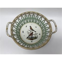 Pair of 19th century German openwork chestnut baskets, with twin handles and scrolling gilt border and star rim, painted to the centre with birds and insects, D22cm 