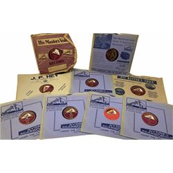 HMV portable wind up gramophone in a black case, together with a collection of records. 