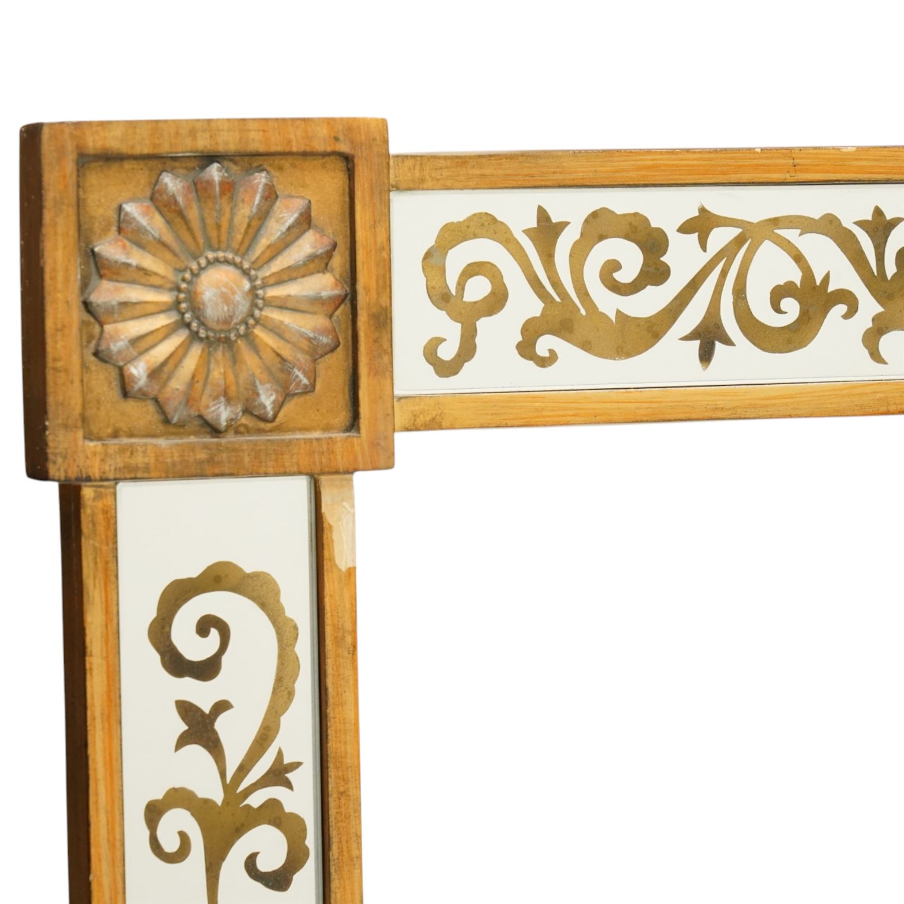 Regency inspired overmantel mirror, decorated with gilt foliate scrolls on the mirrored surrounds, flower and swag applied mounts