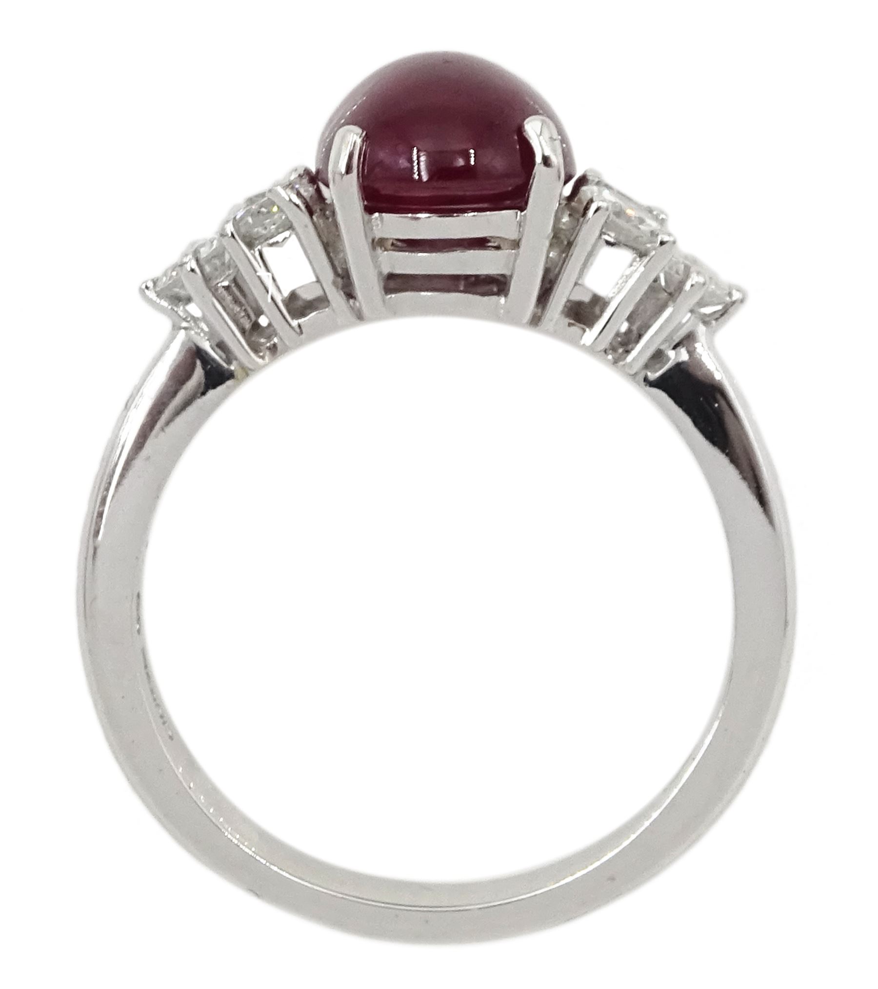 18ct white gold cabochon ruby ring, set with three round brilliant cut diamonds either side, hallmarked, ruby approx 3.20 carat, total diamond weight approx 0.55 carat