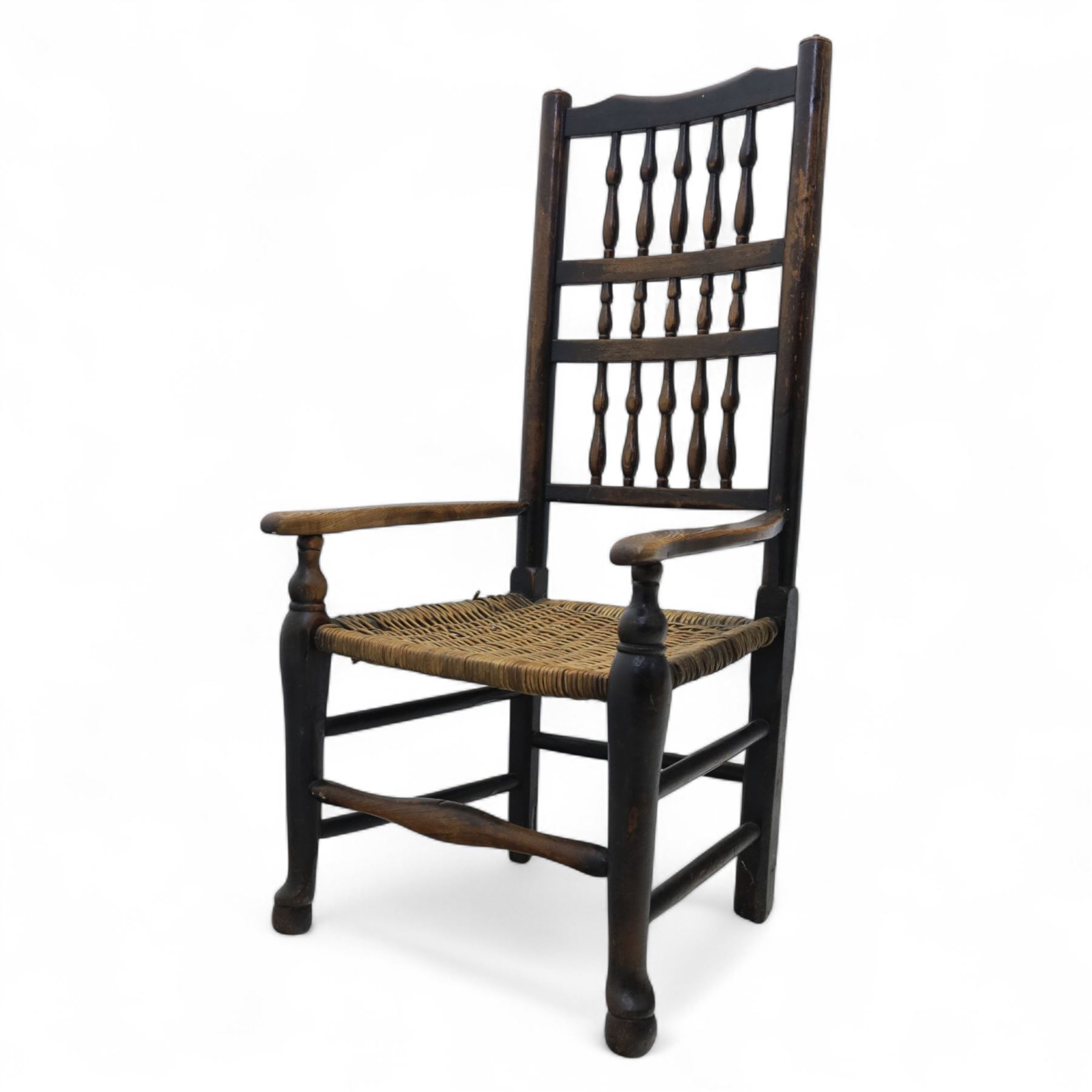19th century country elm spindle back armchair, shaped cresting rail over two rows of turned spindles, shaped open arms over rush seat, on front turned supports, joined by stretchers 
