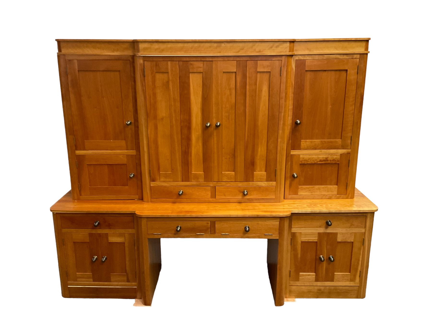 Large contemporary cherry wood break-front wall unit, the banded cornice over double cupboard with bifold doors and two drawers, flanked by four single cupboards, the base fitted with four drawers over four cupboards (W263cm, H216cm, D68cm); and a cherry wood cabinet, fitted with double cupboard over two short and two long drawers, with faux drawer facias (W81cm, H138cm, D66cm)