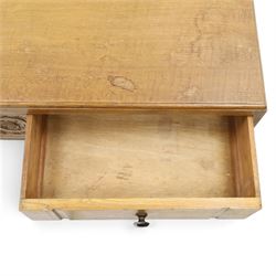 Leemings of Halifax (est. 1872) - Arts & Crafts oak side table, rectangular caddy top with raised moulded back, the frieze carved with central Yorkshire rose motif flanked by two drawers, raised on twin stylised lyre end supports formed of C-scrolls, united by shaped stretcher