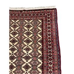 North East Persian Turkoman rug, ivory ground field decorated with repeating Gul motifs, multi-band border decorated with geometric patterns and motifs