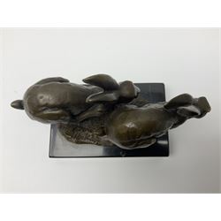 Bronze figure group, modelled as two hares in chase, upon a naturalistic base signed Nick and with foundry mark, raised upon a rectangular marble base, overall H12cm. 