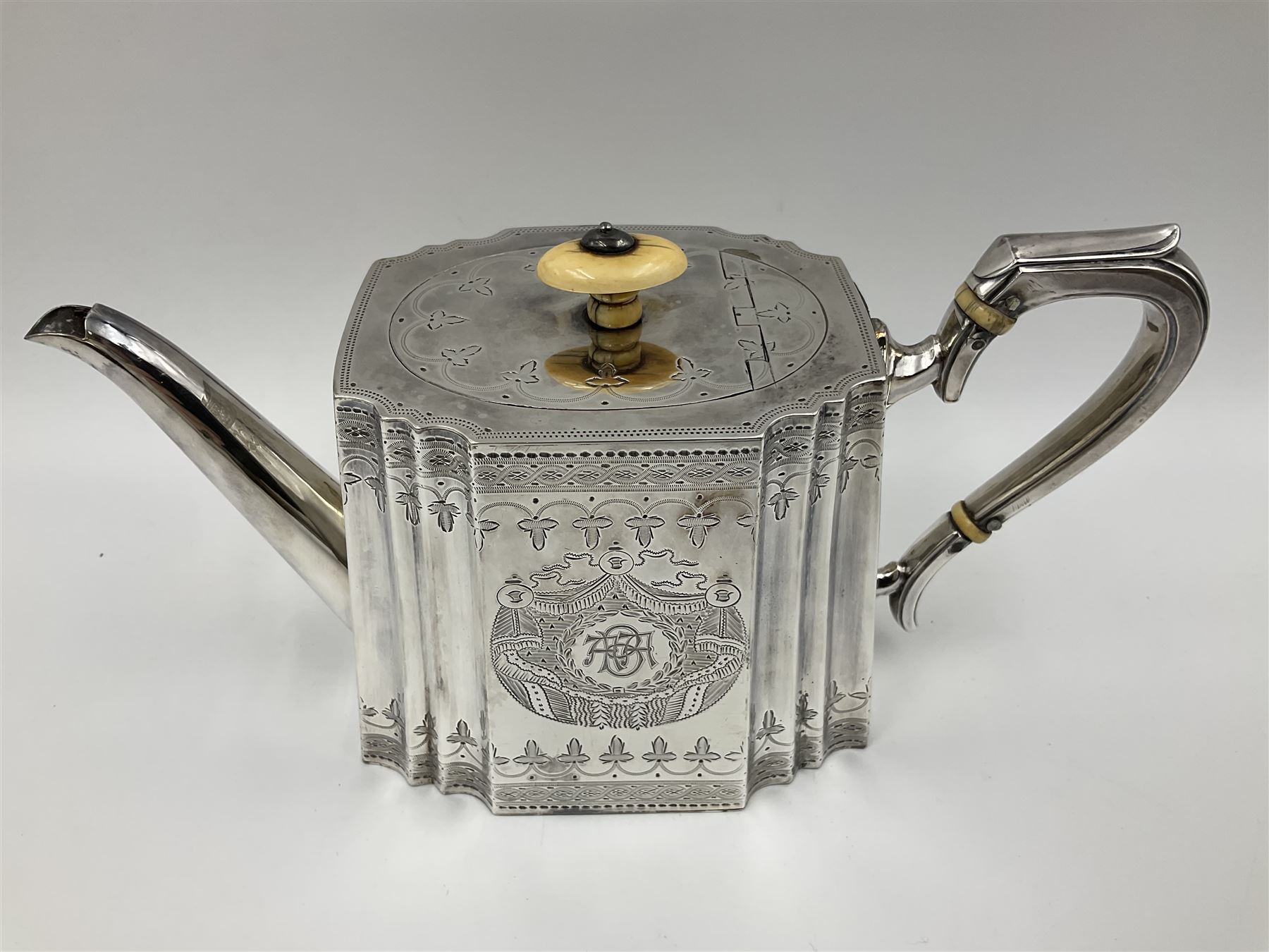 Victorian three-piece silver tea service, comprising teapot, twin handled open sucrier and milk jug, of oval form with shaped rim and C handles, each engraved with crests and bands of strapwork decoration, the milk jug and sucrier with gilt interiors, hallmarked Josiah Williams & Co, Exeter 1881, the teapot with ivory insulators and finial, all contained with a tooled leather, blue silk and velvet lined fitted case, retailed by West & Sun, Dublin 
This item has been registered for sale under Section 10 of the APHA Ivory Act