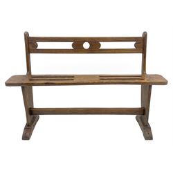 19th century country elm child’s joined bench, the pierced back rest and seat supported by shaped end supports joined by stretcher, on sledge feet 