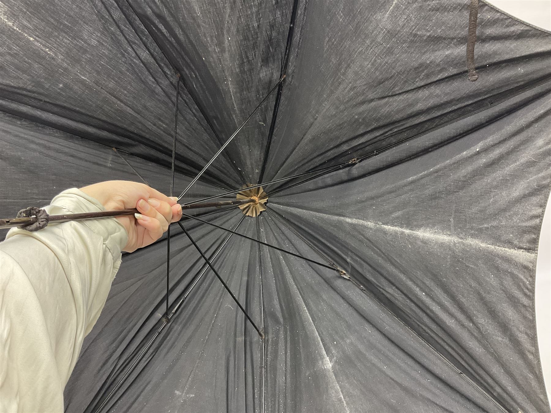 Early 20th century curved horn handle walking stick with hallmarked silver mounts, engraved L Russell 1918, together with a shooting stick by William Mills Birmingham, with leather handle, 'The Featherwaite' shooting stick and an umbrella with wooden handle