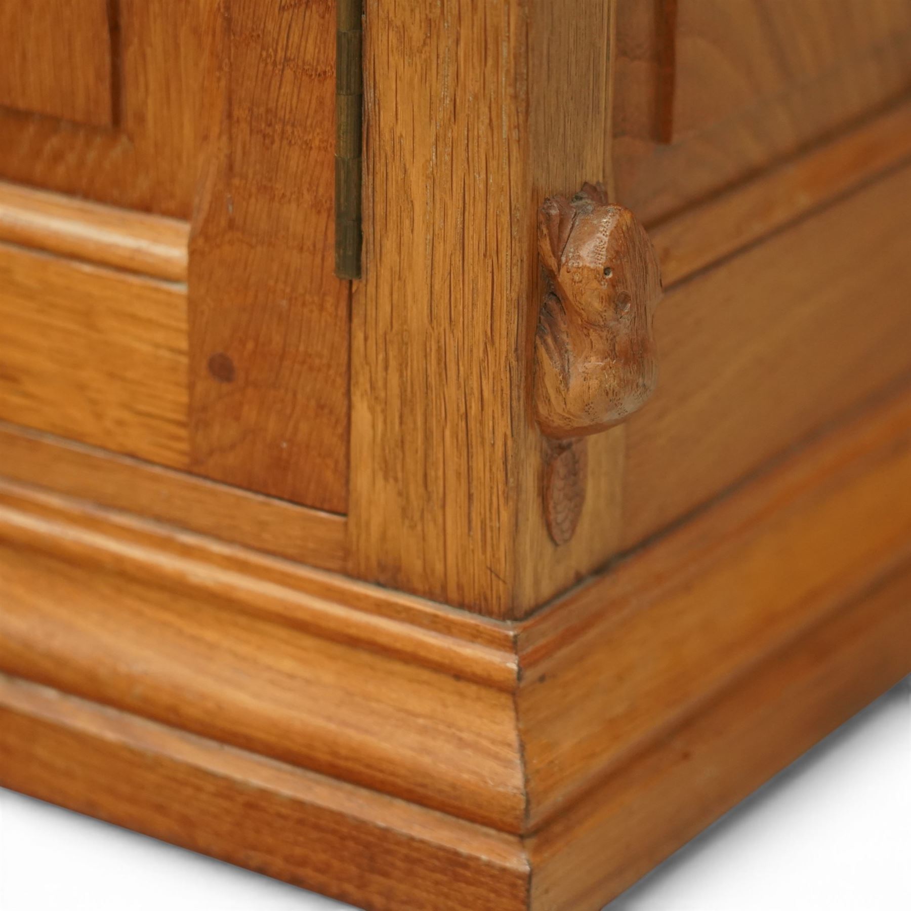 Beaverman - oak media cabinet, rectangular top with interictally carved panels to the side and front doors, twin doors with Yorkshire Rose carved wooden knob, enclosing a staggered shelf arrangement above two drawers, raised on a moulded plinth base, with carved beaver signature, by Colin Almack of Sutton near Thirsk