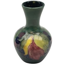 Moorcroft vase, decorated in the Leaf and Berries pattern upon a tonal green ground, together with a further Moorcroft vase, of squat baluster form, decorated in the Iris pattern upon a tonal green ground, each with impressed marks beneath, each H9cm. 