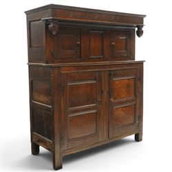 Early 18th century oak court cupboard, the projecting cornice carved with initials 'WKIW' and dated 1718 with turned terminals, fitted with two recessed panelled cupboard doors, large cupboard to base, raised on stile supports