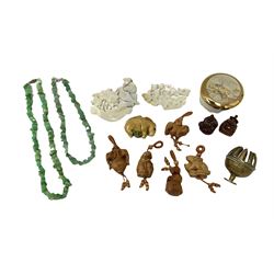 Japanese carved wood netsukes modelled as animals to include rabbit and bear with beaded strings, two Buddha figures, mother of pearl panels carved with birds and foliage, jadeite necklaces, brass bell etc