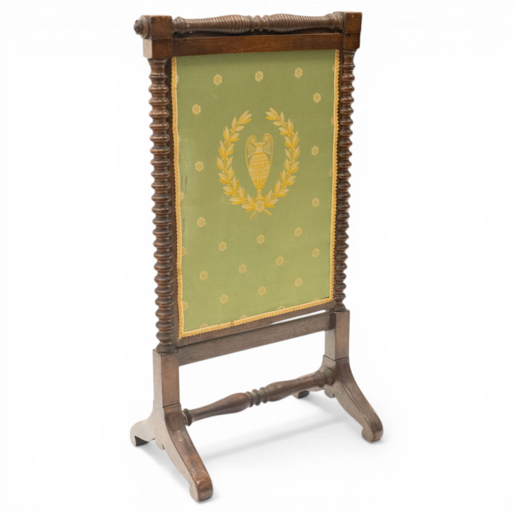 Victorian mahogany firescreen, the rectangular upholstered panel decorated with a Greek urn within laurel wreath on green ground, within spiral turned uprights, on downswept supports united by a turned stretcher