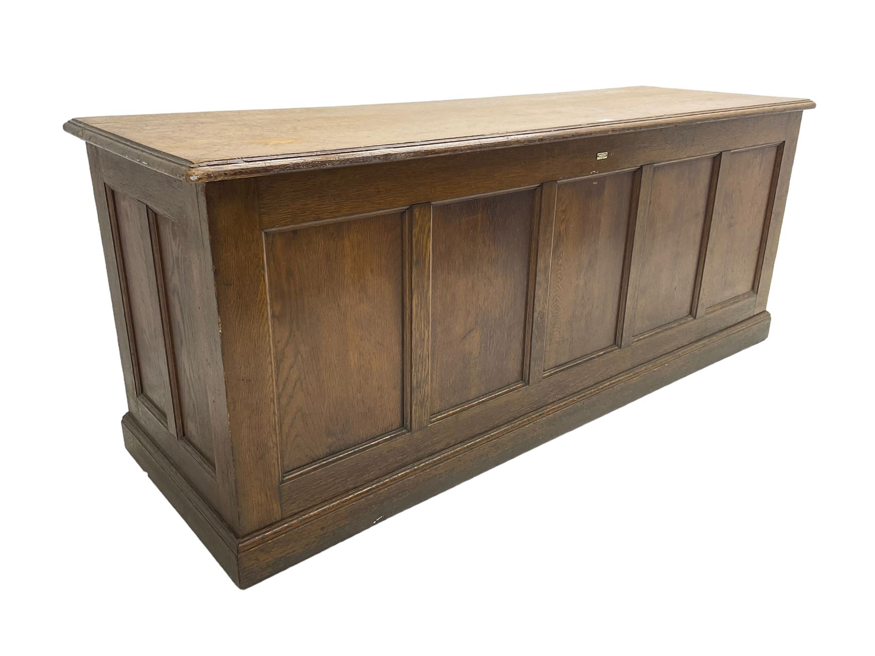 Illingworth Ingham and Co. School Furnishers (Leeds c1900) - early 20th century oak rostrum or headmaster's desk, rectangular top, the front and sides panelled with open reverse, on plinth base