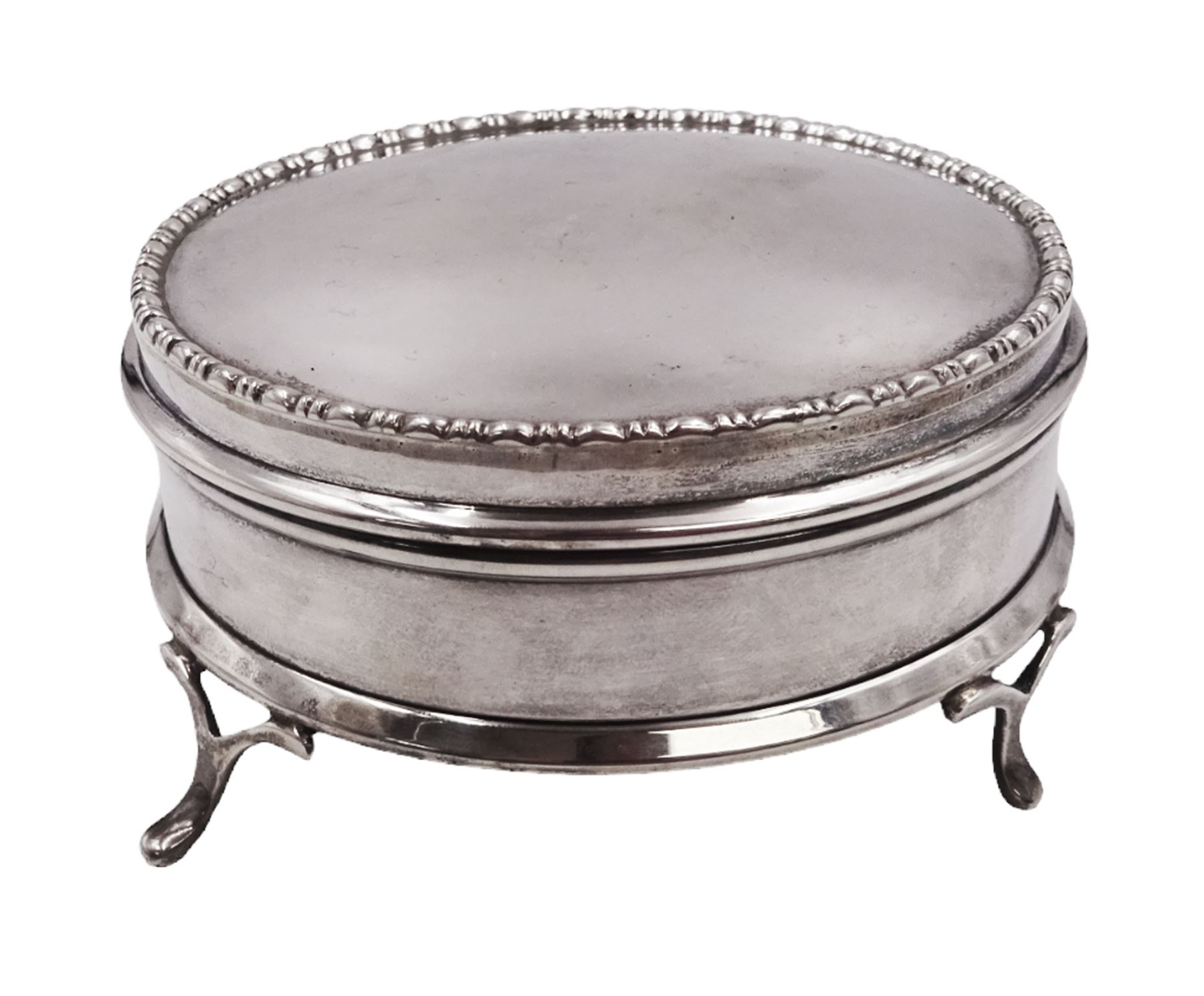 1920s silver mounted jewellery box, of circular form, with bead and dart rim to hinged cover, opening to reveal gilt velvet lined interior, upon four pad feet, hallmarked Charles Edwards, London 1920, H4.5cm