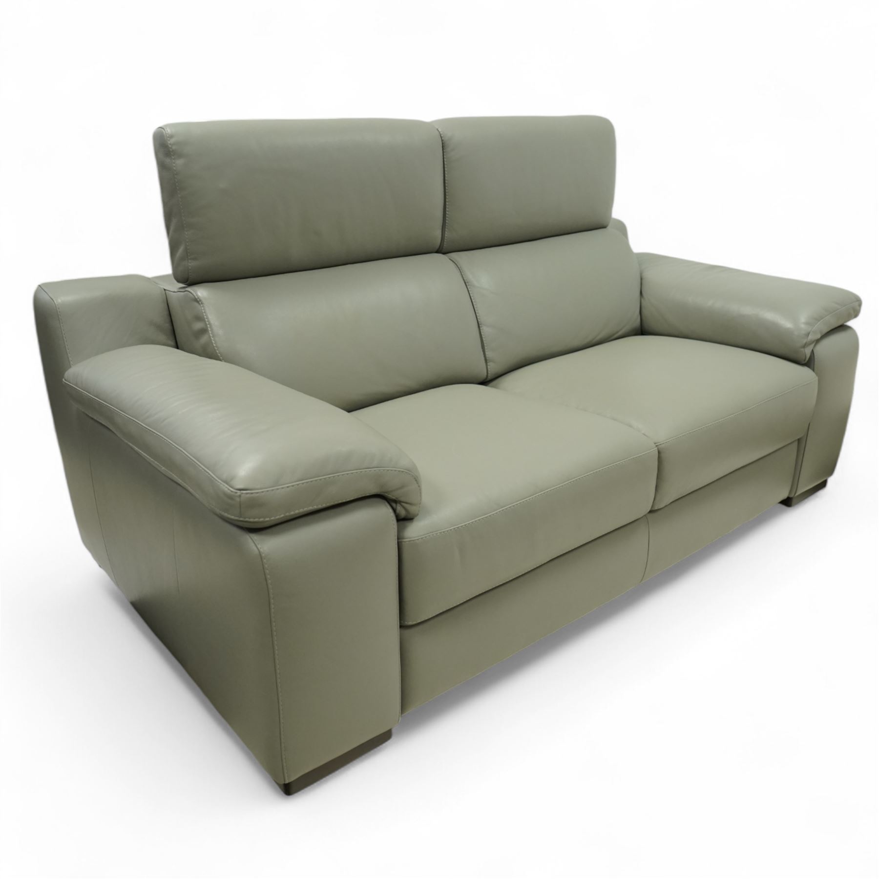 Modern Italian style leather two-seat sofa, upholstered in pale grey leather with panel stitched cushioning, with retractable head rests and broad arms, raised on square feet