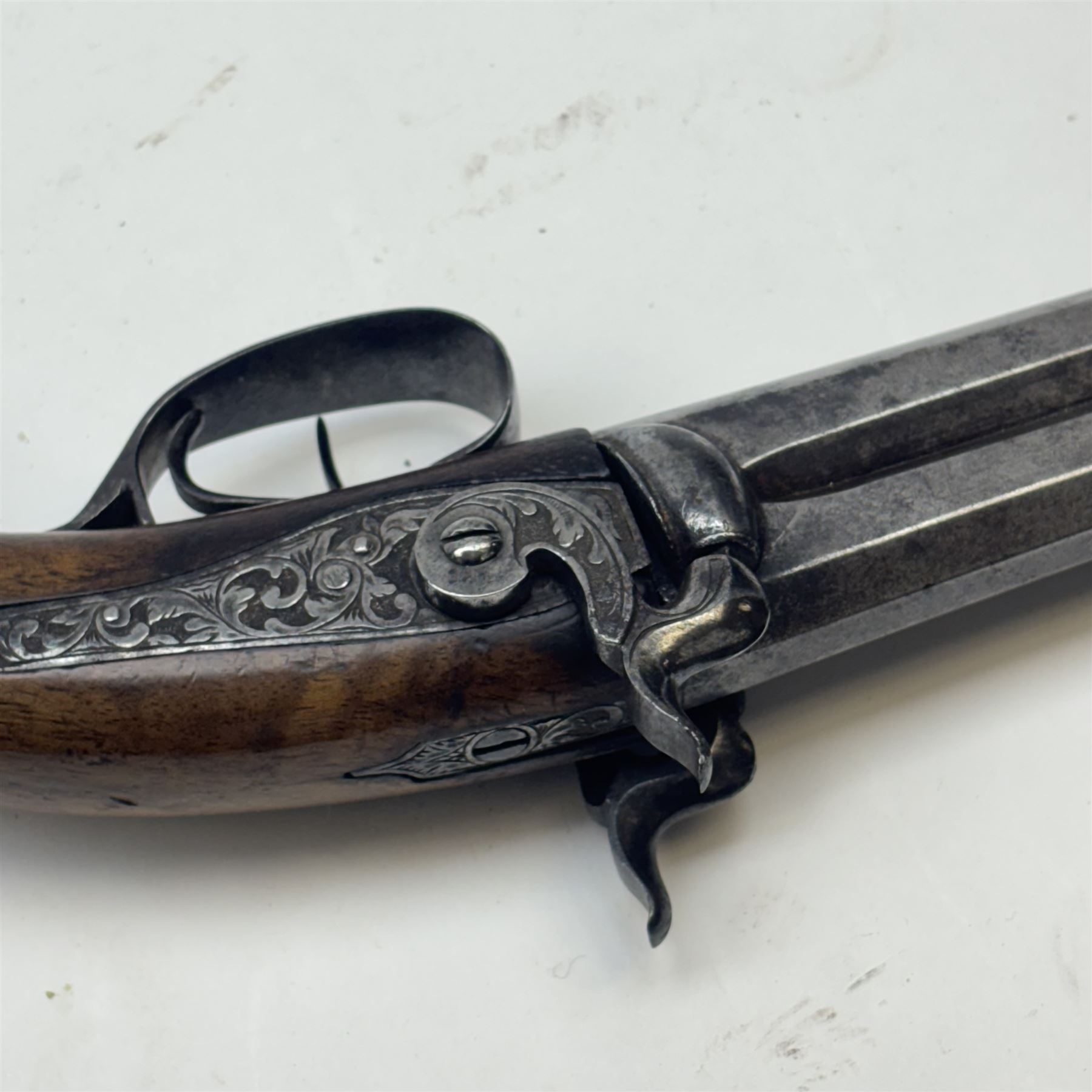 19th century double-barrelled percussion pistol, the octagonal, over and under, barrels with remains of the signature 