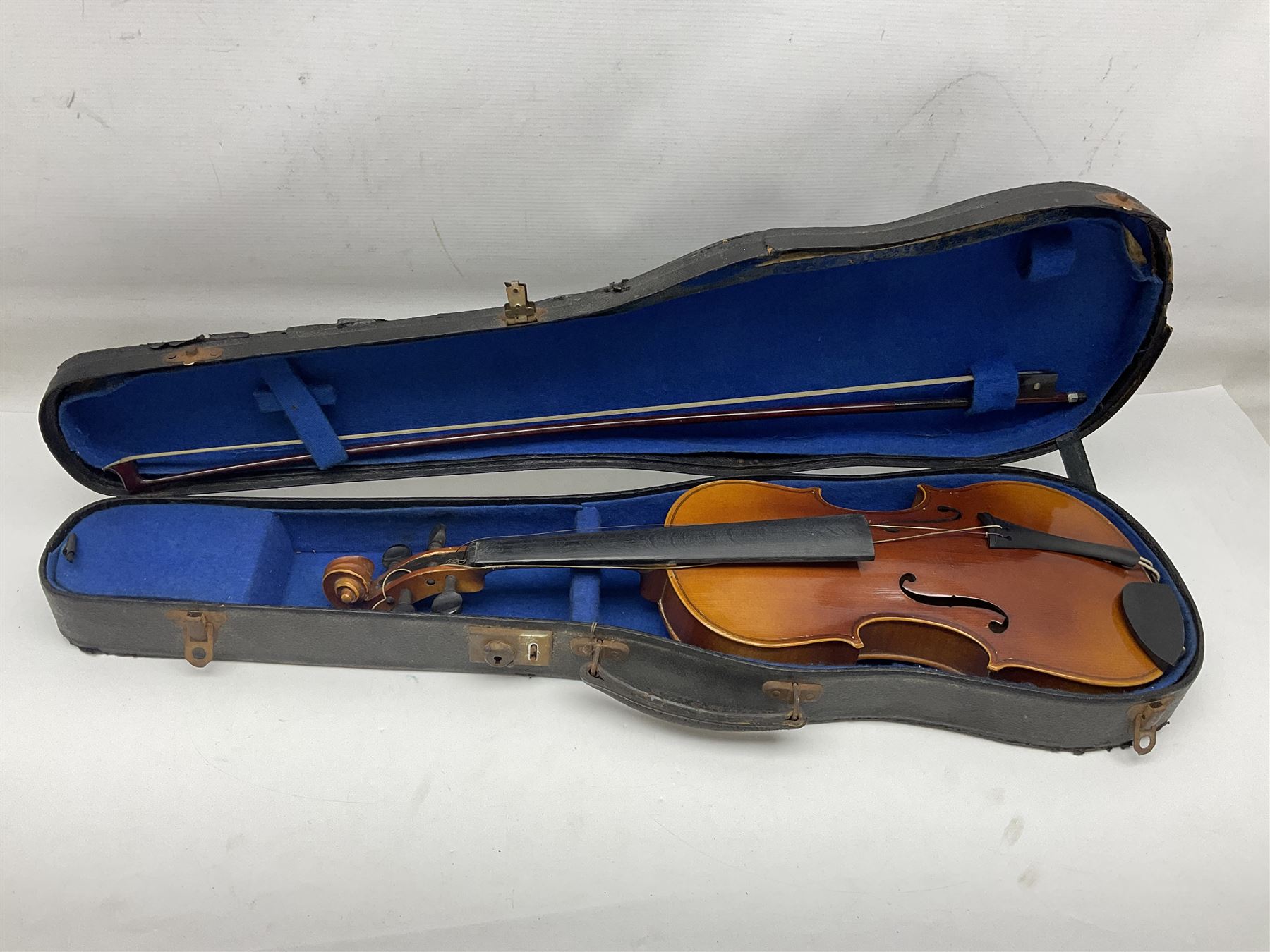 Czechoslovakian violin c1920 with 36cm two-piece maple back and ribs and spruce top, bears label 'Copy of Antonius Stradivarius Made in Czechoslovakia' L59cm; in carrying case; 1950s Czechoslovakian violin; and 195os Czechoslovakian three-quarter size violin; both cased (3)