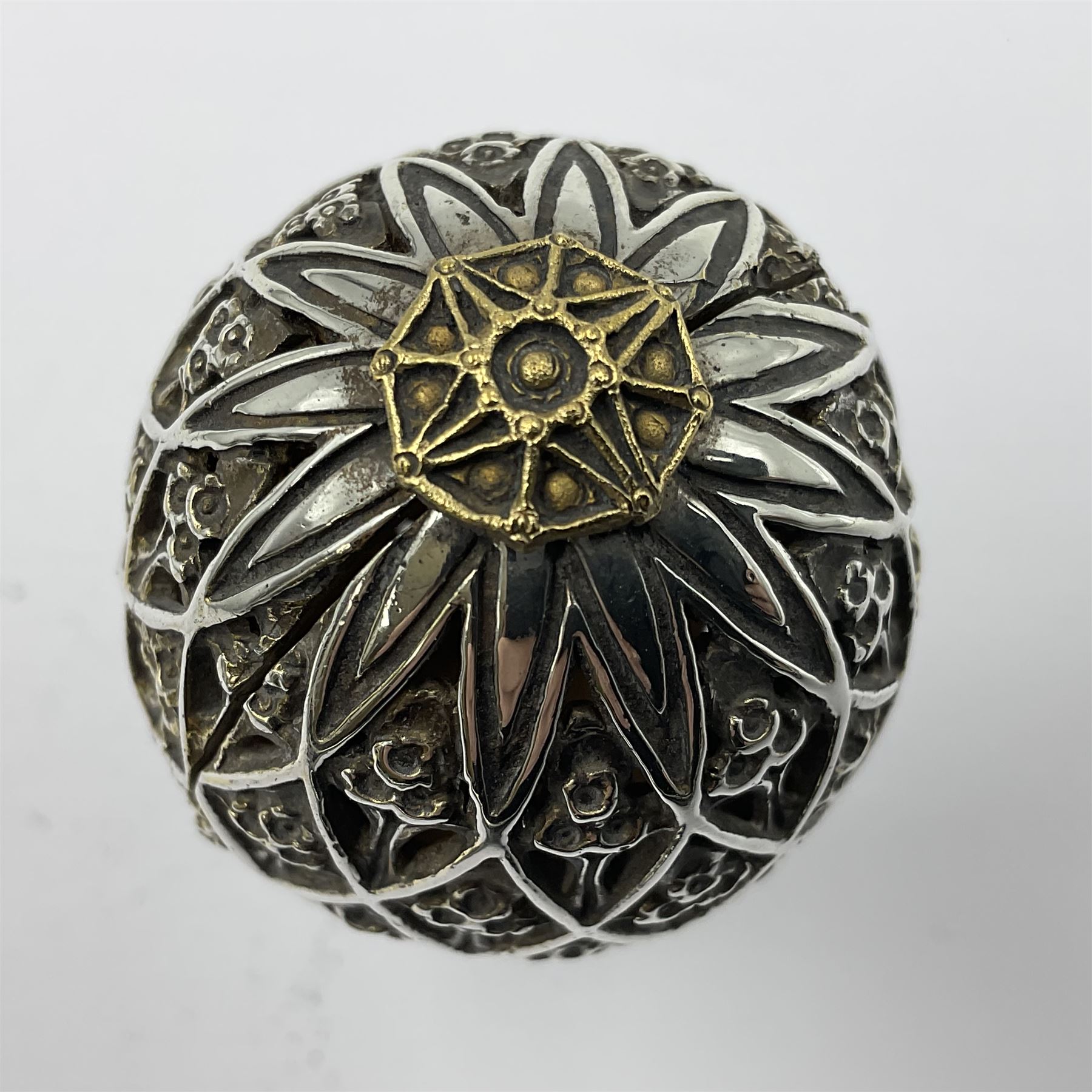 Modern silver limited edition Easter egg, no. 70/500, the openwork lattice body decorated with gilded panels of flower heads, opening to reveal a gilt interior, upon silver stand with three scrolling pad feet, each hallmarked St James House Company, London 1979, height including stand 8cm