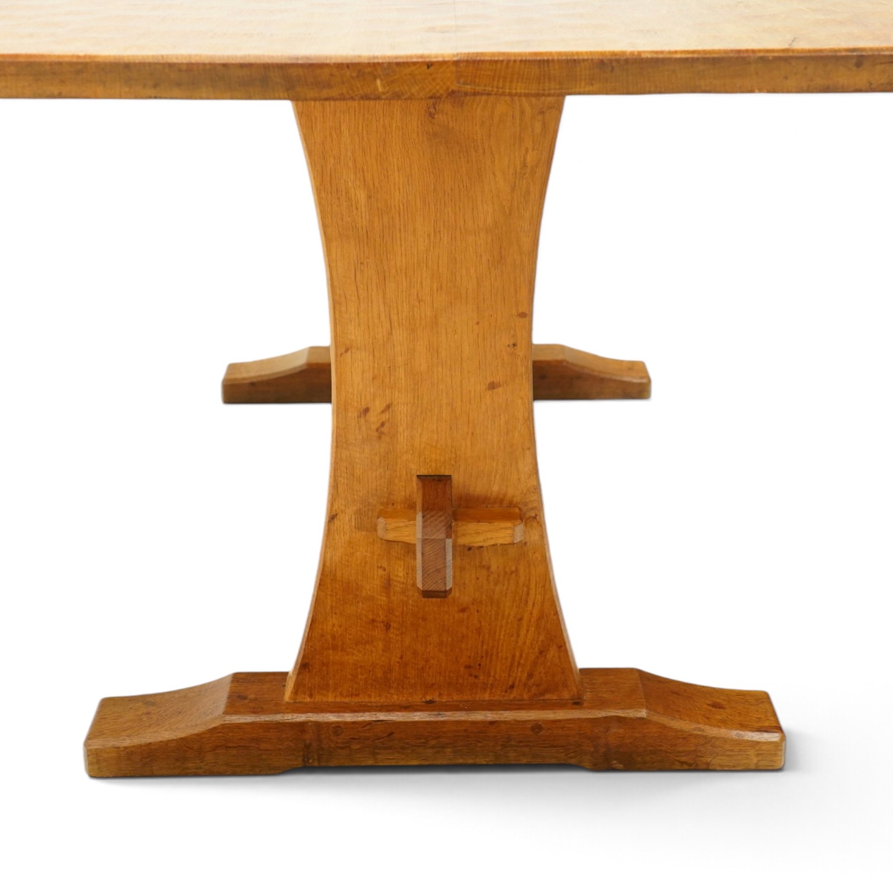 Acornman - adzed oak refectory dining table, rectangular adzed top with rounded corners raised on twin shaped end supports terminating to sledge feet united by pegged stretcher, carved with acorn signature