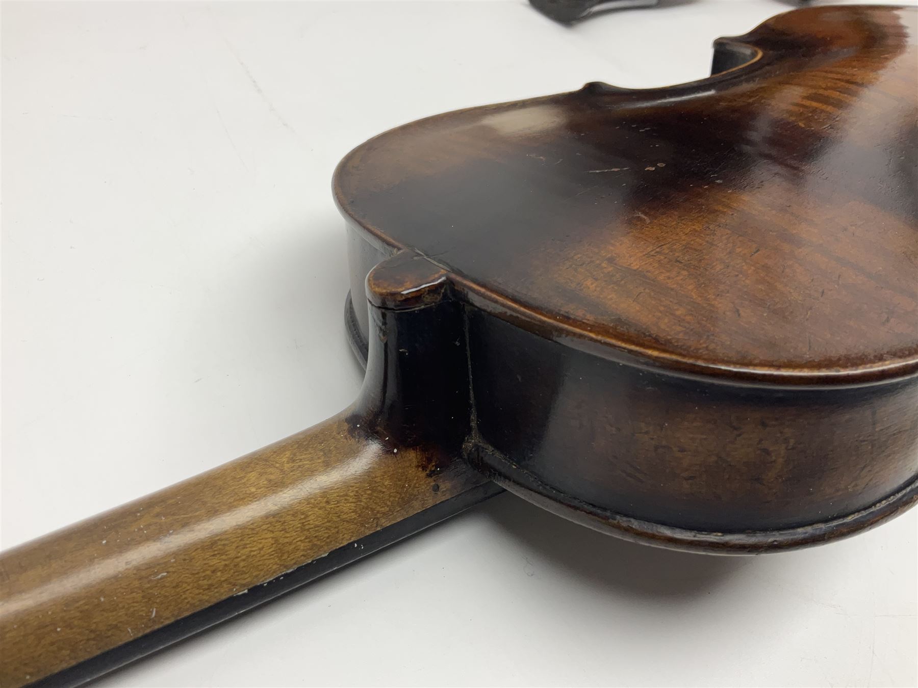 German violin c1890 with 36cm two-piece maple back and ribs and spruce top; bears label 'Antonius Stradivarius Cremona Faciebat Anno 1729' L59.5cm overall; in ebonised wooden 'coffin' case; and two German violins c1890 for completion - one bearing a Stradivarius label, the other a Ruggeri label; both in carrying cases (3)