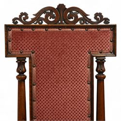 Victorian walnut high back hall chair, with pierced and scrolled crested rail above a rectangular back and seat upholstered in plush cerise fabric, flanked by tulip carved and turned uprights raised on turned and tapered front legs  