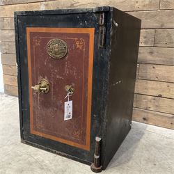 Samuel Withers & Co of West Bromwich - Victorian cast iron safe, the brass handle modelled as a clenched fist, painted in red, orange and black, with key. Ground floor delivery only, no steps.