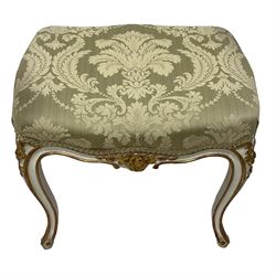 20th century French design parcel gilt and painted dressing table stool, upholstered in sage green damask fabric, shaped form on floral carved cabriole supports, with matching cushion 