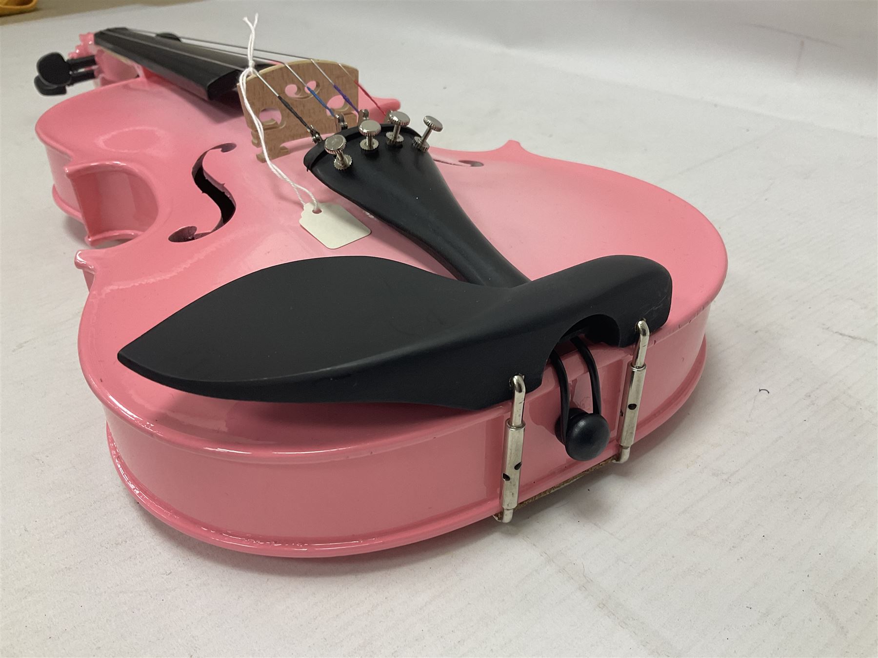 Zest full size pink violin, with a solid wood body and maple head, with matching pink bow and two further bows, in a hard case Length 60cm