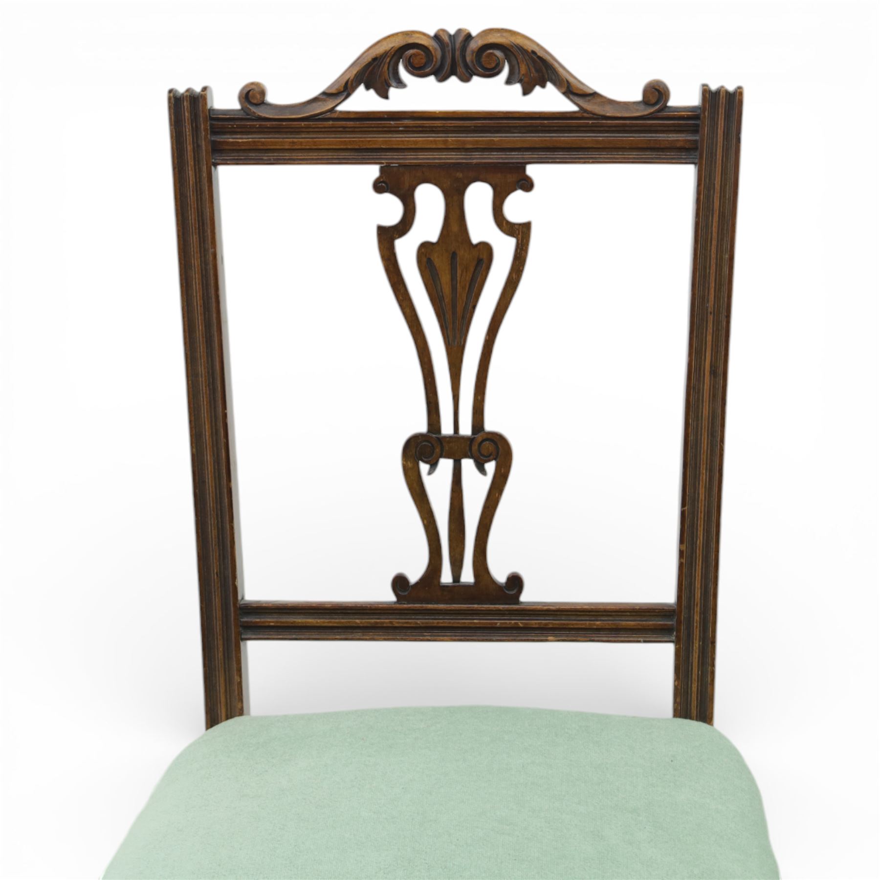 Late Victorian mahogany side chair, the carved cresting rail above a pierced and carved splat with lyre-form detail, the back panel inset with cane work, drop-in upholstered seat in pale green fabric with braid trim, raised on cabriole supports