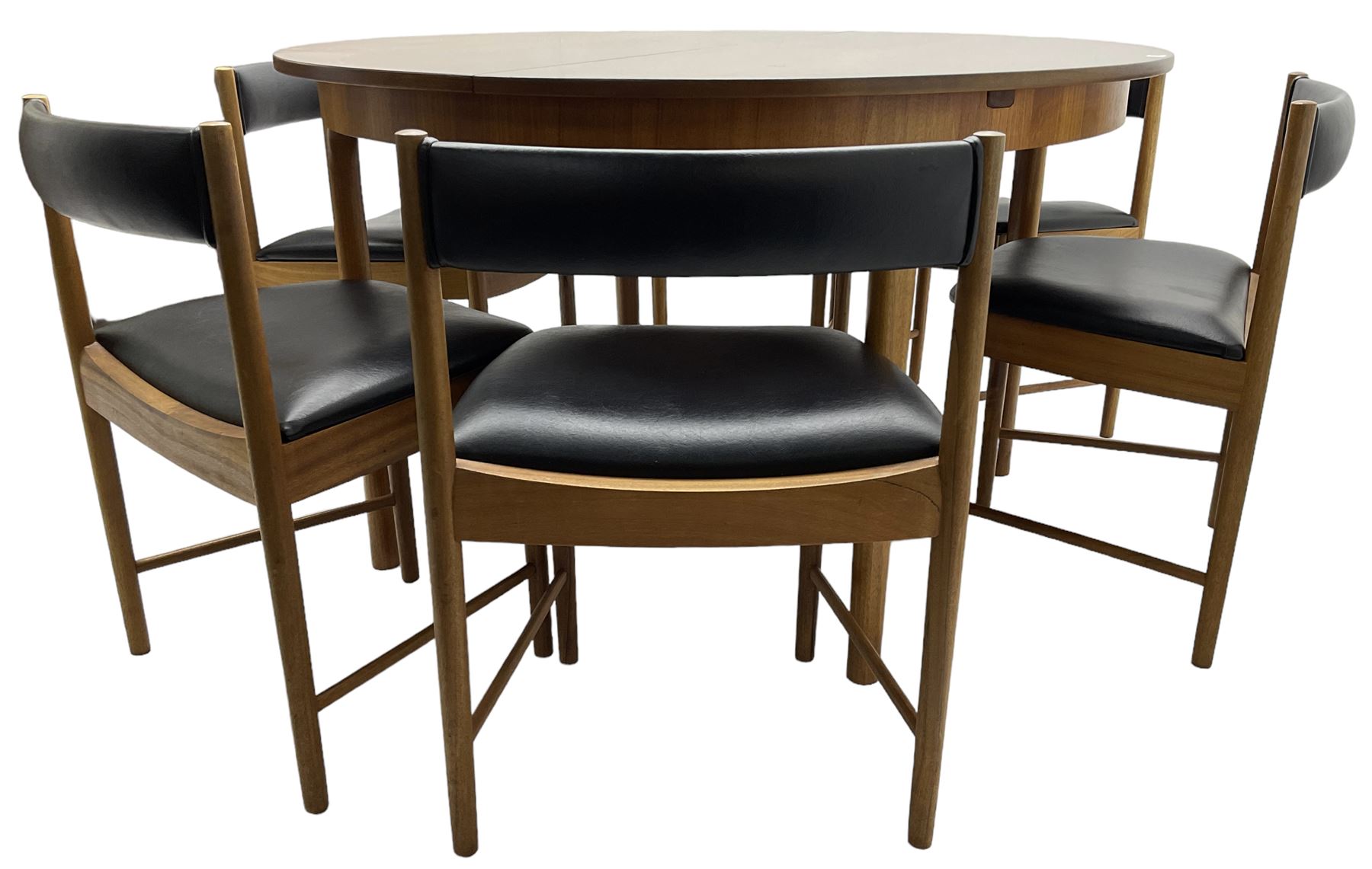AH McIntosh & Co of Kirkaldy - mid-20th century teak extending dining table, circular top, concealed integrated double leaf, raised on tapered supports, label plaque to underside of leaf, together with a set of six chairs upholstered in black leatherette