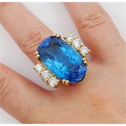 18ct gold oval blue topaz ring, with four round brilliant cut diamonds set either side, topaz approx 31.10 carat, total diamond weight approx 2.25 carat