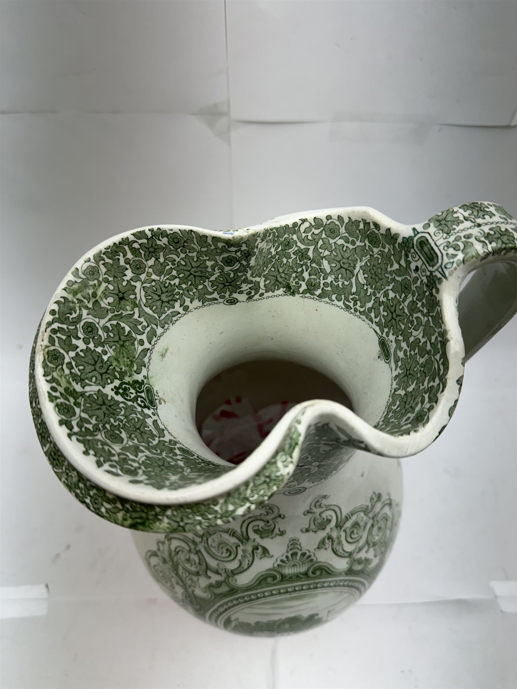 19th century Copeland & Garrett New Blanche wash jug, with green transfer printed decoration of 'West Cowes', H36cm, together with a treacle glaze pottery puzzle jug, H28cm