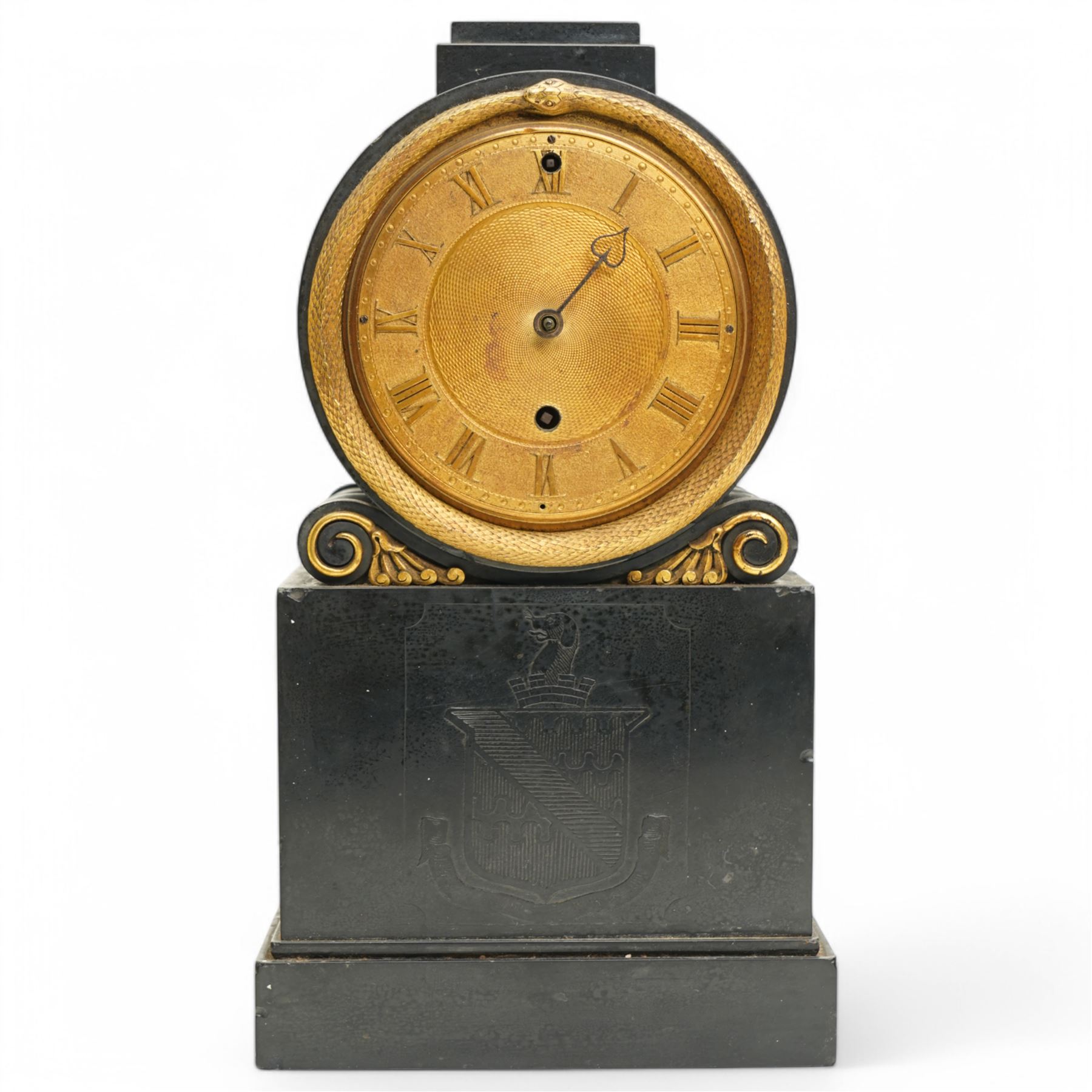Benjamin Vulliamy of London- a small Regency 8-day ormolu and black marble mantle timepiece c1820, circular movement with a drum housing cradled on decorated scroll supports and a stepped marble plinth, the front of the plinth faintly incised with an armorial coat of arms, 3-1/2