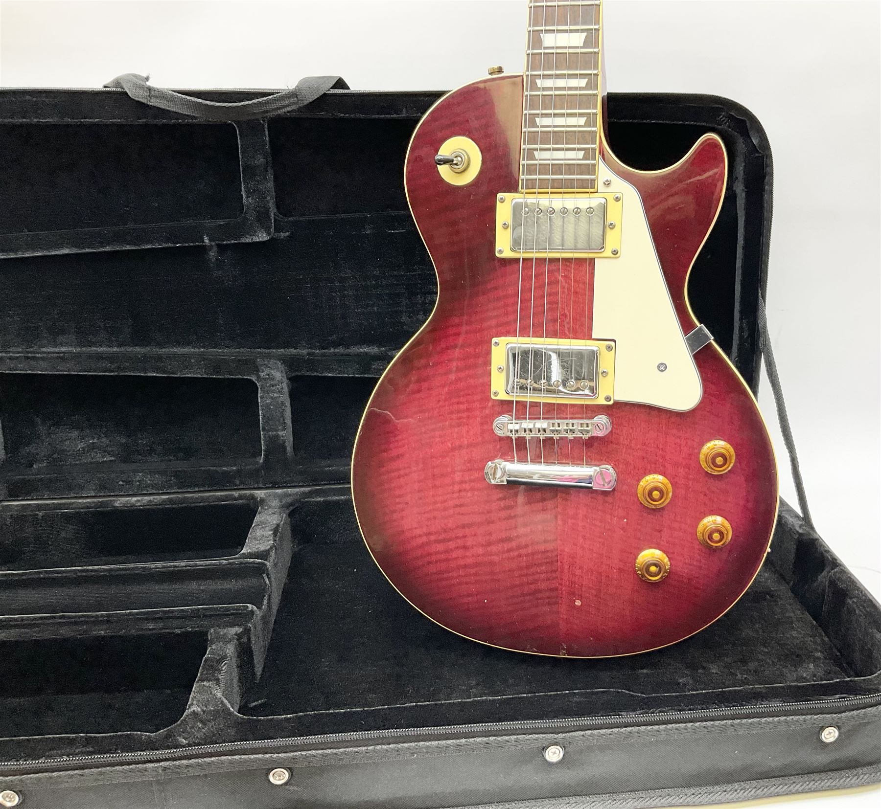 1980s Les Paul Epiphone limited edition cut-away electric guitar by Gibson, the burgundy coloured body with two pick-ups, volume and tone knobs and scratch plate, original tuning pegs, serial no.U6030215, 101cm overall; in modern Kinsman fitted carrying case