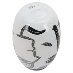 Kosta Boda Open Minds glass footed bowl, the clear glass bowl painted with female facial features, together with a Kosta Boda Caramba vase, of baluster form painted in black with a head in profile and a two headed beast on a white ground, both designed by Ulrica Hydman-Vallien, tallest H19.5cm